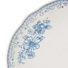 Close-up of blue floral illustration on stoneware salad plate rim