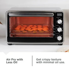 Air fryer toaster oven with interior rack holding food on mesh tray