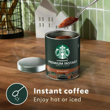 Starbucks premium instant medium roast can with scoop of coffee grounds