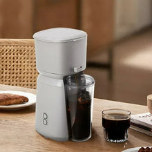 Single serve iced coffee maker with frosted lid and clear ice jar
