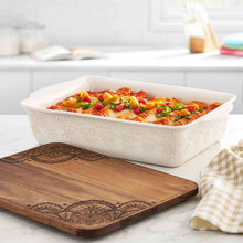 Rectangular ceramic casserole dish with embossed linen pattern and matching dark wood lid