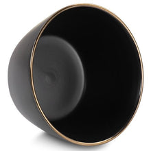 Matt black stoneware bowl interior with thin gold rim, round bowl close-up