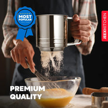 Stainless steel sifter cup releasing flour through fine mesh