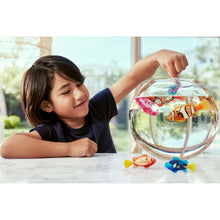 Clear globe aquarium with orange patterned fish toy