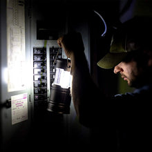 Lit LED camping lantern shining in a dark setting