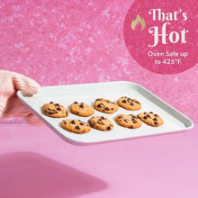 Pink ceramic nonstick cookie sheet holding baked cookies