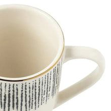 Stoneware mug interior and handle with black drip print on body