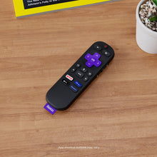 Black Roku voice remote with purple center navigation and channel shortcut buttons