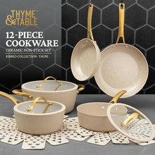 Taupe ceramic nonstick cookware set with ribbed pots, glass lids, and gold handles