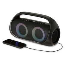 Portable FM boombox with LED-lit speaker rings connected to a smartphone via cable