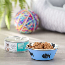 Wet cat food paté shown in bowls with can beside on tabletop