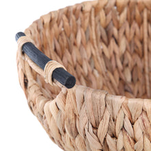Close-up of woven water hyacinth decorative bowl handle attachment with black cap details