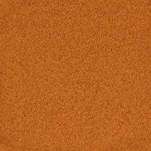 Ground cinnamon powder texture in close-up, orange-brown