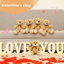 Small brown plush teddy bears with bow ties in a row
