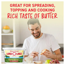 Salted whipped butter tub with man holding bread and spreading butter