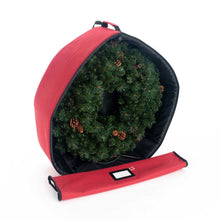 Red storage bag open around a green wreath with pinecones