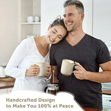 Cream ceramic coffee mugs with handles, held by two people