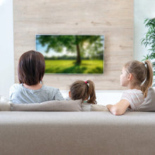 Living room with family watching TV; indoor antenna reception setup