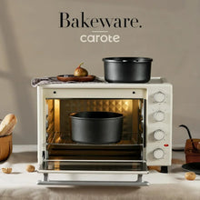 Nonstick black baking pot in an oven, with door open