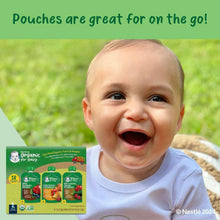 Baby with Gerber Organic baby food pouch variety pack in an outdoor setting