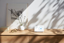 Chalk smart display on a wooden tabletop in a sunlit room