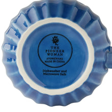 Underside of blue stoneware mug with round maker stamp