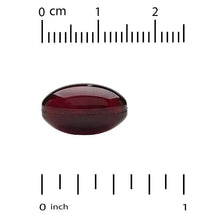 Astaxanthin softgel, dark red, shown with size ruler