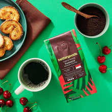 Sumatra ground coffee bag with a cup of dark coffee and pastries