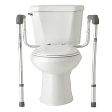 Toilet safety rails with cushioned gray grips, mounted on a standard toilet