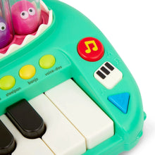 Green crocodile piano control panel with yellow buttons, black keys, and piano symbols