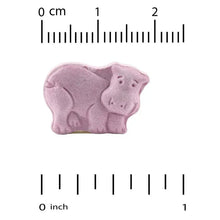 Purple chewable magnesium tablets shaped like a pig, with size ruler