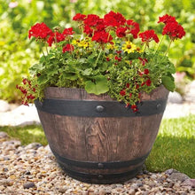 Barrel wood planter with dark green band and red and green flowers