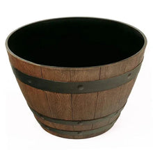 Wooden barrel planter with dark green bands and black interior