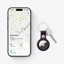 Apple AirTag on a keyring with an iPhone showing a location map