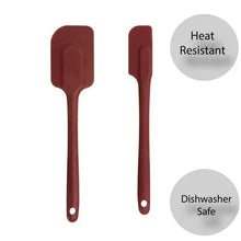 Two red silicone spatulas with flat solid heads and long handles, loop holes