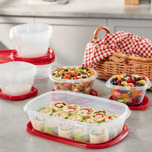 Red-lidded plastic food containers with assorted prepared snacks and cupcakes
