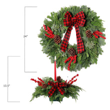 Fresh holly wreath with red plaid bow, pinecones, and red berries; includes candle centerpiece