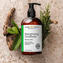 Strengthening conditioner bottle with pump, amber bottle with rosemary mint sprigs