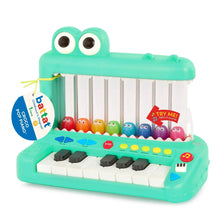 Green crocodile pop piano toy with character drums, keyboard keys, and hanging tag