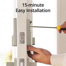 Smart door lock latch on door edge with hands tightening hardware during installation