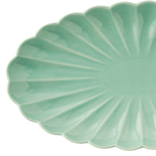 Green leaf-shaped stoneware serving tray with glossy ridged surface