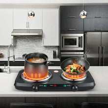Portable double burner hot plate with two pots over glowing coil burners