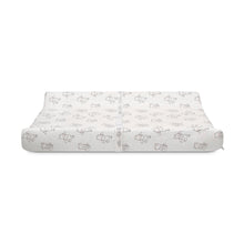 Contoured changing pad with white plush cover and stitched edges, bear character print
