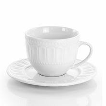 White ceramic mug with embossed sides and matching saucer