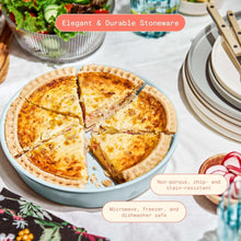 Light blue stoneware pie dish holding baked quiche with sliced wedges