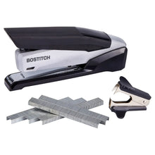 BOSTITCH desktop stapler with dark gray body, plus staple remover and loose staples