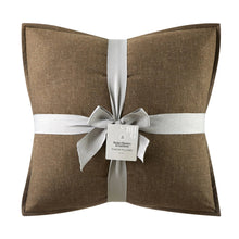 Brown linen square throw pillows with white ribbon band and bow