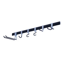 Utility storage rail with black bar and metal hooks for wall organization