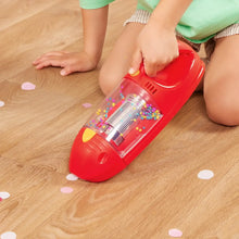 Red toy vacuum with clear drum and colorful swirling beads inside the chamber