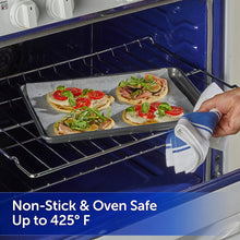 Reynolds Kitchens parchment sheet in baking pan on oven rack with food